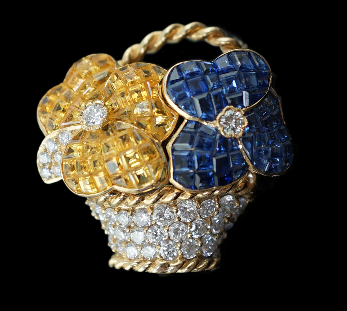 A Tiffany & Co 18k gold, two colour sapphire and diamond cluster set brooch, modelled as a basket with two flower heads